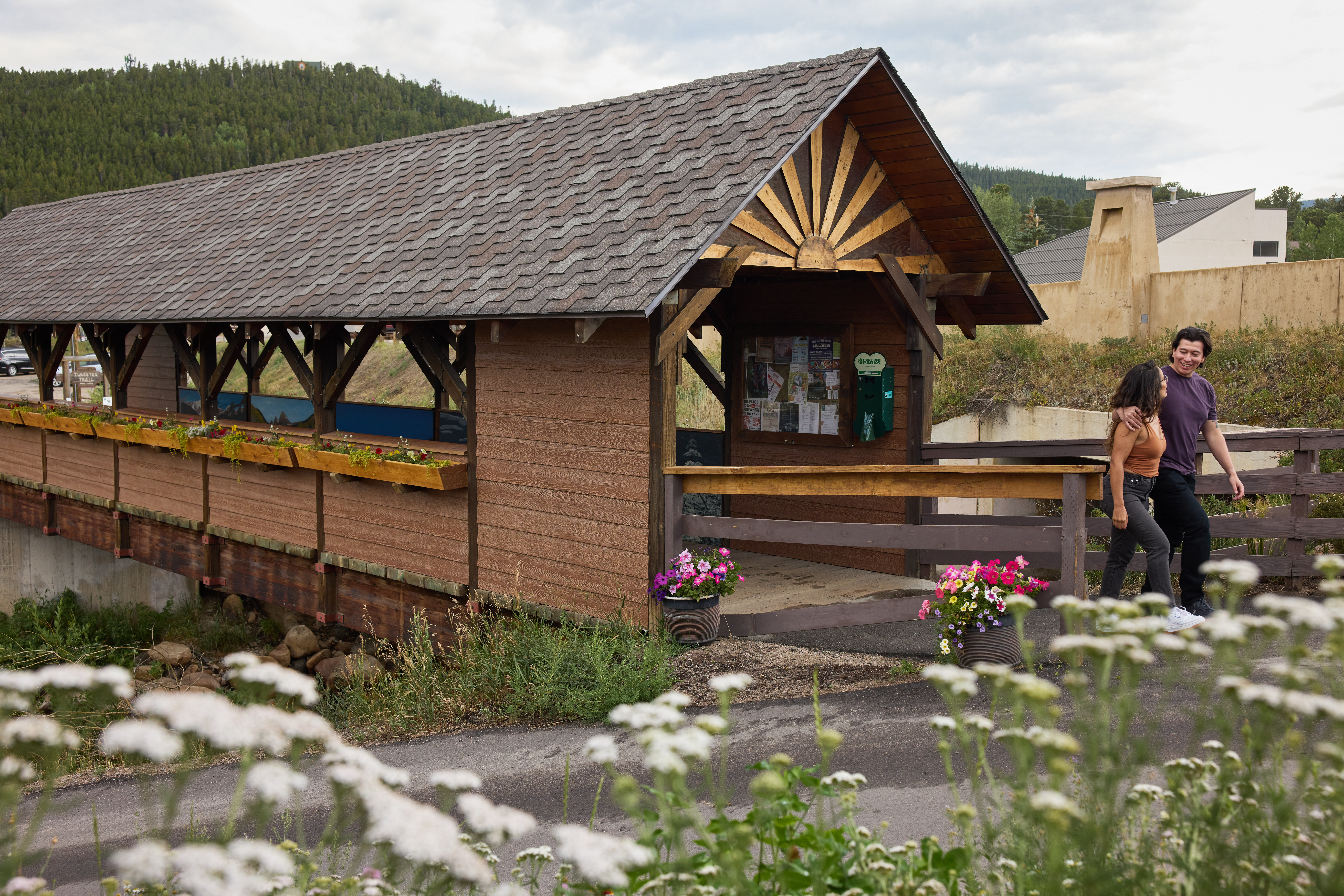 Photograph of two people walking out of the Nederland pedestrian bridge.