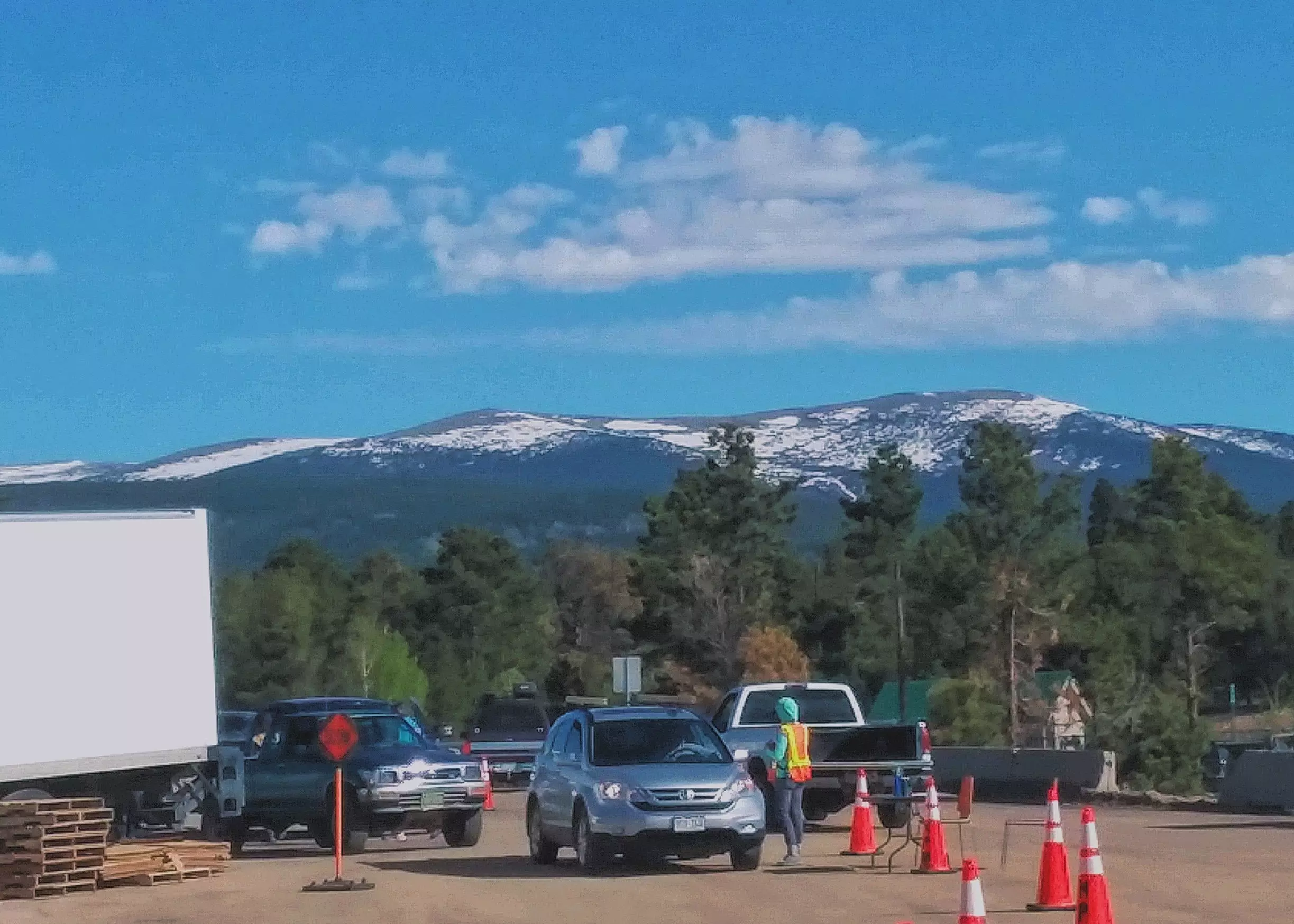 Cars line up outside the Transfer Station. The Indian Peaks can be seen in the background